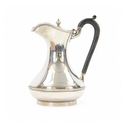 1930s silver hot water pot, of bellied form engraved with monogram to body, with Bakelite type handle and urn finial, hallmarked Fattorini & Sons Ltd, Birmingham 1938, H23cm