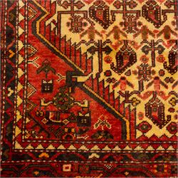 North West Persian Malayer hand-knotted rug, ivory field with central stepped lozenge medallion with angular pendants, surrounded by rows of stylized boteh and geometric floral devices within multiple geometric and stylized vine borders, with fringe ends