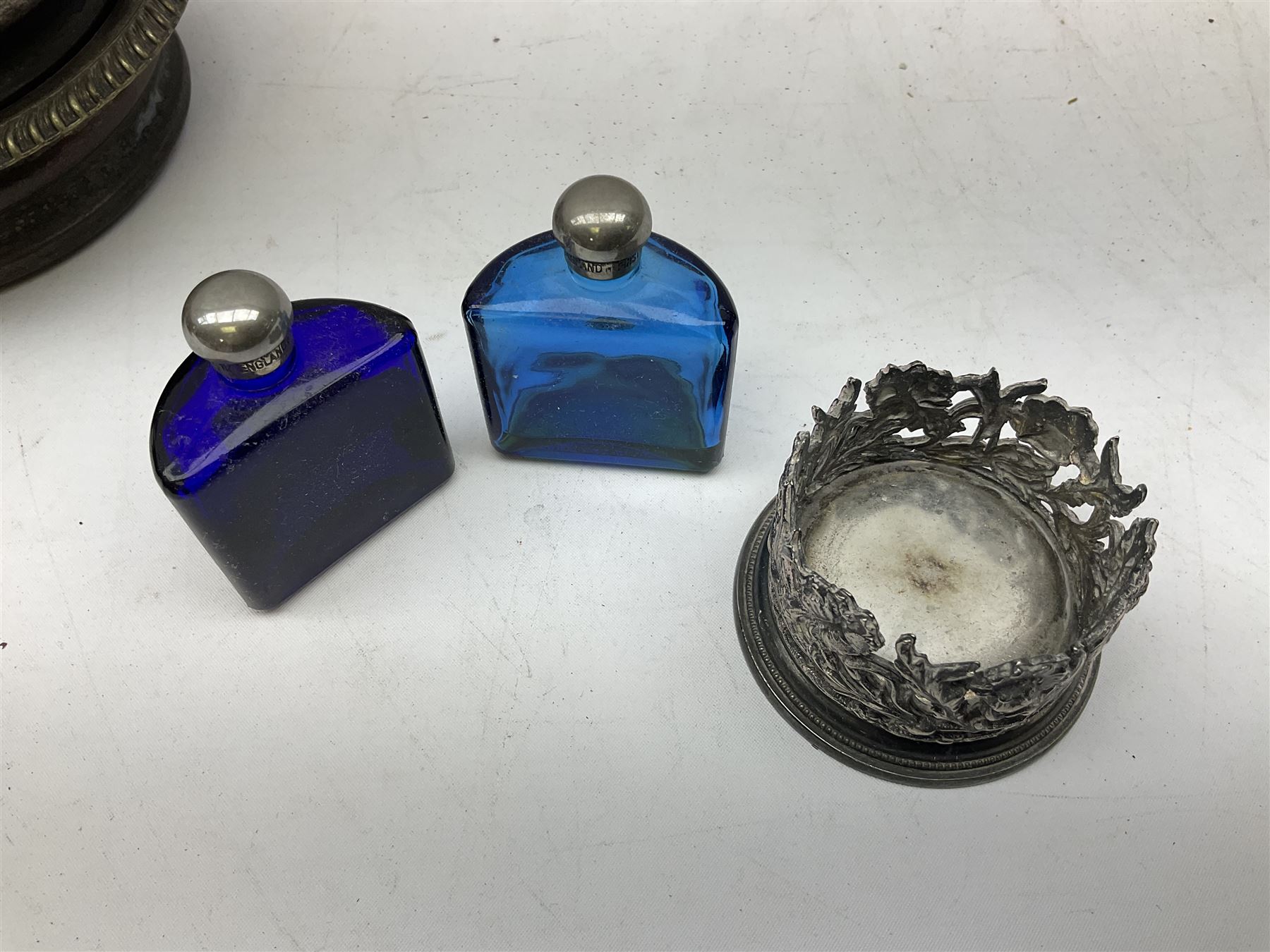 Four 19th century silver plated wine bottle coasters, together with hallmarked silver collared and lidded glass cruet trio and ornate silver cruet holder missing liner, with handle, and other silver plate etc