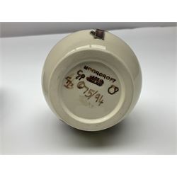 Moorcroft dish and cover, of circular form, decorated in Buttercup pattern, together with a Moorcroft vase, of baluster form, decorated in Magnolia pattern, both with printed marks beneath, tallest H9.5cm