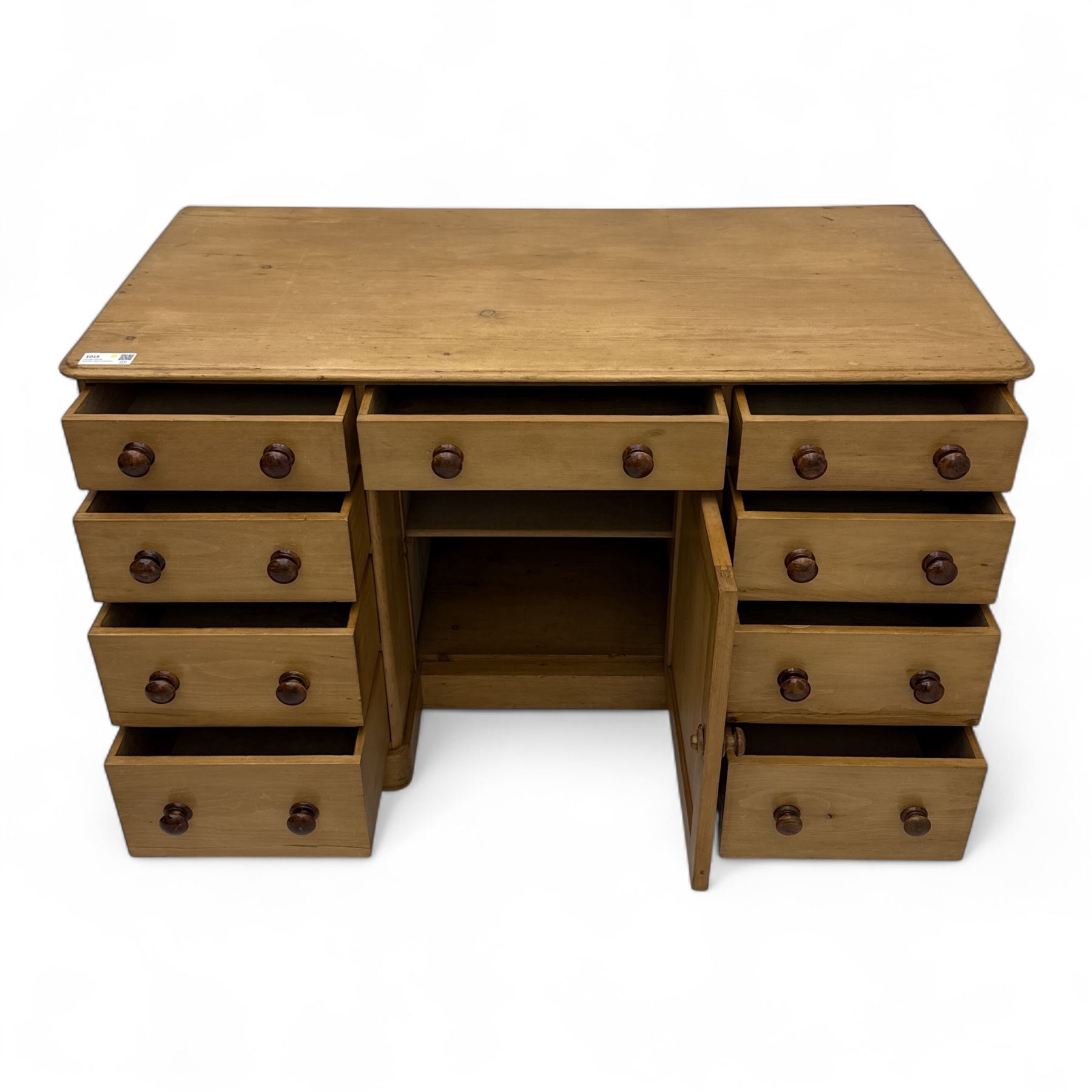 Late 19th-century Victorian stripped pine twin pedestal kneehole dressing table, the rectangular top above three short and three graduated drawers on each pedestal and a central cupboard, on a moulded plinth base 