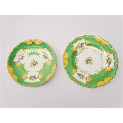 19th century Minton tea set, comprising twelve teacups, eleven saucers, fifteen side plates, cream jug, slop bowl, and two cake plates, decorated with panels of floral sprays, upon a green ground, heightened with gilt throughout, with printed puce mark beneath, and pattern number 5329
