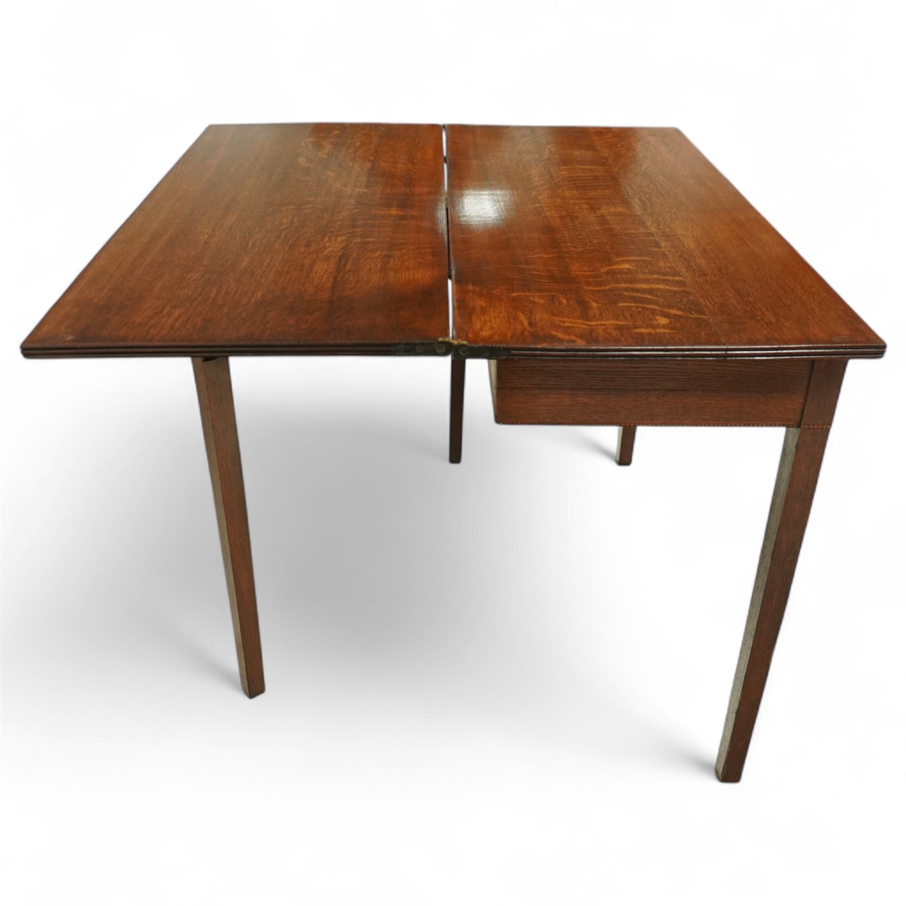 Early 20th century oak side table, rectangular top over single frieze drawer with brass ring handle, raised on square tapering supports