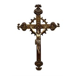 Oak crucifix carved with flowers, the cross mounted with bronzed metal depiction of Christ, L90cm