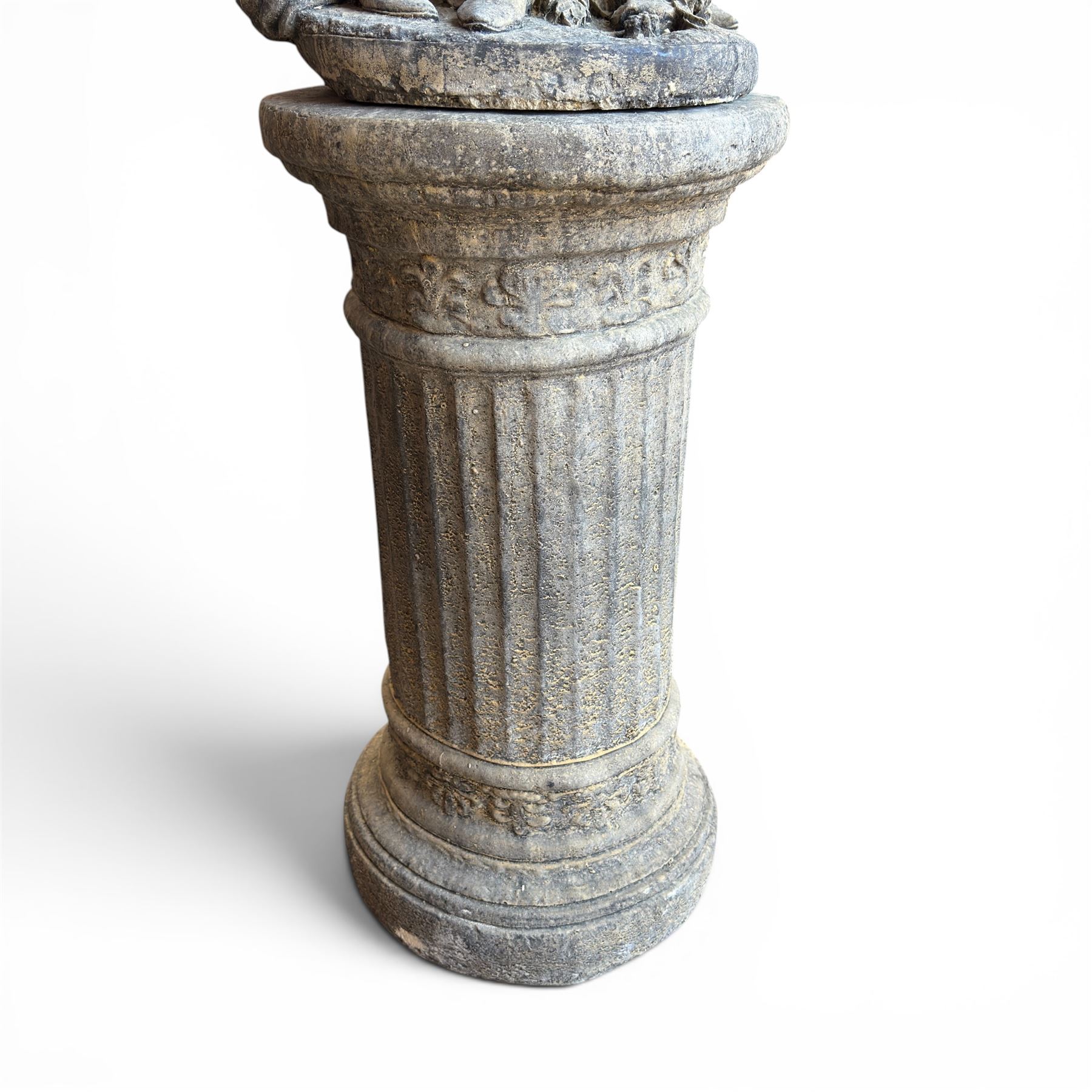 Composite garden statue group of Romeo and Juliet embracing, the couple adorned in Medieval dress standing on a naturalistic base with fallen flowers, raised on a Neoclassical fluted pedestal with Anthemion leaf motifs