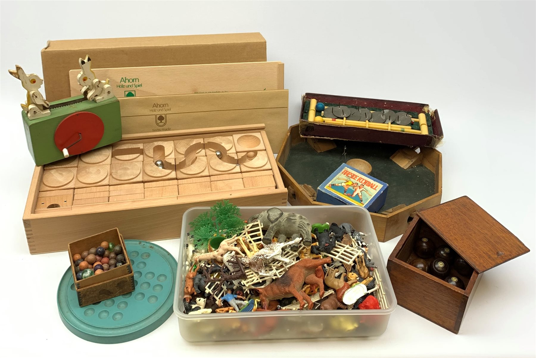 Bussey's Table Croquet Game in part box; set of eight hardwood table top bowling woods with jack in mahogany box; blue painted solitaire board with quantity of clay marbles; as new Rollo-Quick wooden rollerball kit in box with slip case; wooden Tiddlywinks game; quantity of Britains and other plastic wild animal figures etc