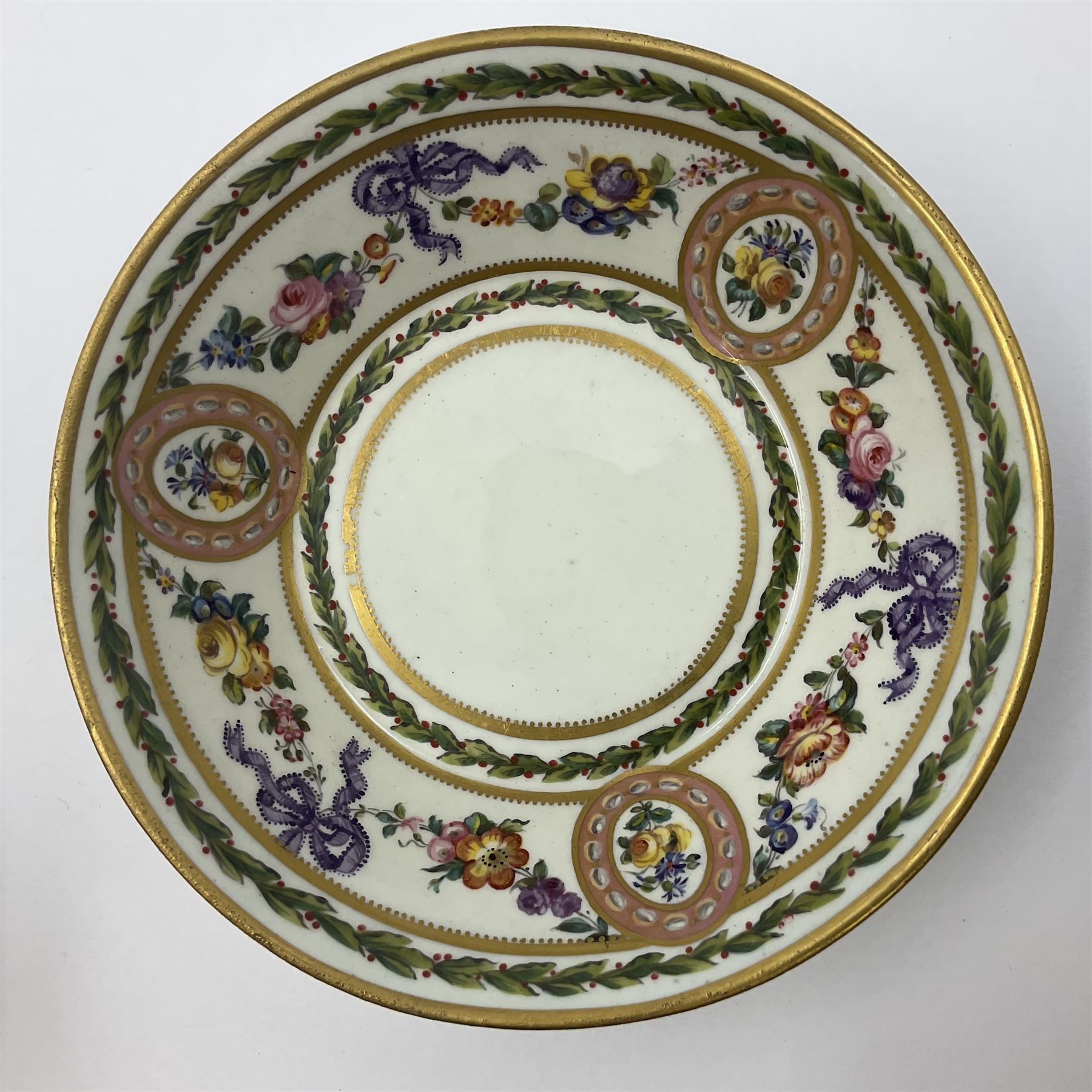 Sèvres soft paste porcelain coffee can and saucer with date code for 1780, painted with pink oval panels bordering bouquets of flowers, united by swags of flowers tied with purple ribbons, within laurel leaf borders, interlaced LL monogram enclosing date letters CC above painters marks for Nicquet, coffee can H7.5cm, saucer D15cm