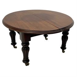 Victorian mahogany extending dining table, circular telescopic extending top with moulded edge, two additional leaves, on turned and lobe carved supports with brass and ceramic castors 