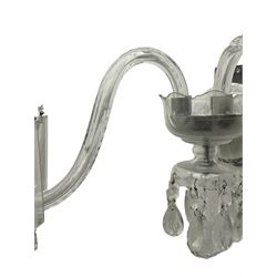 Pair of cut glass two branch wall sconce candelabras, each with S scroll extending branches with shaped and bevelled circular drip trays, hung with pendant drops