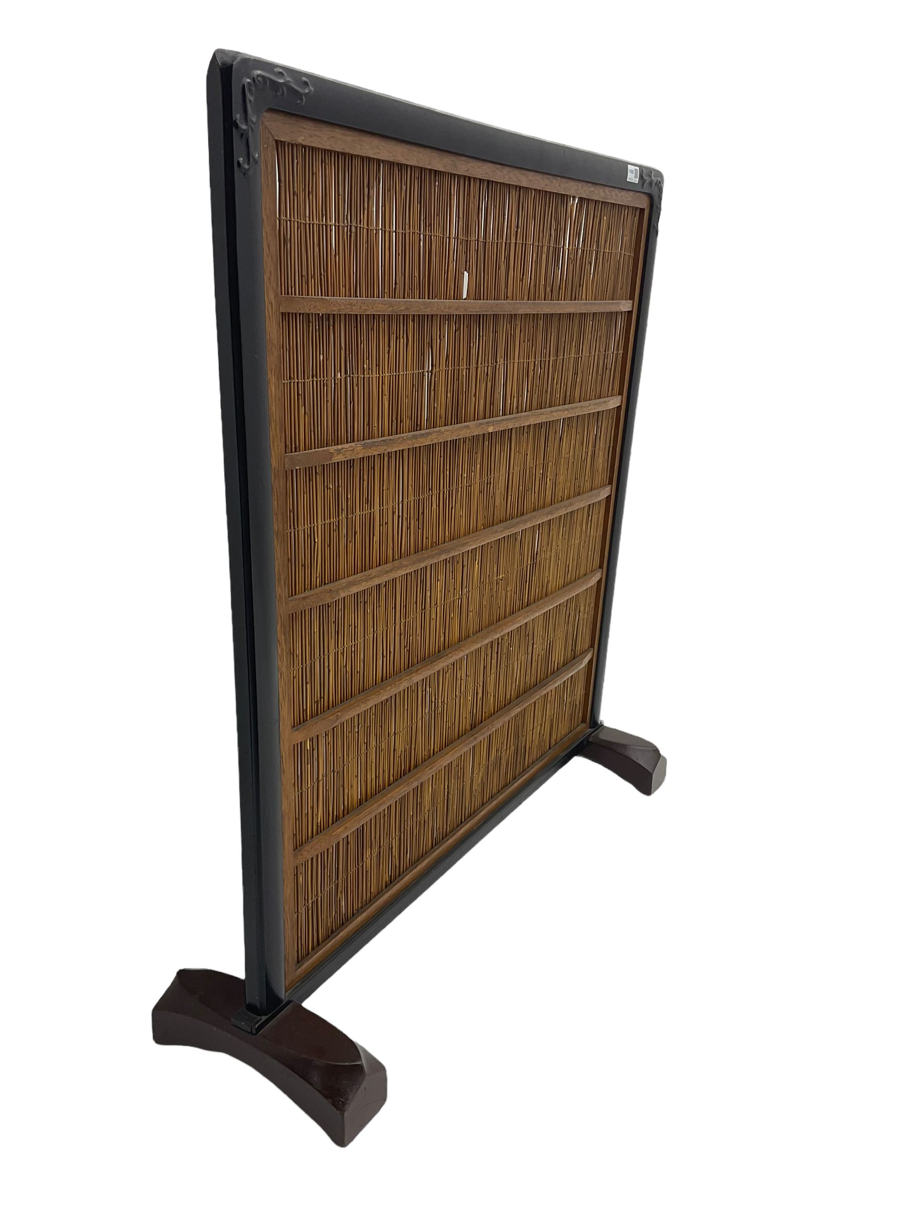 Chinese ebonised hardwood and reed work screen, with carved scroll