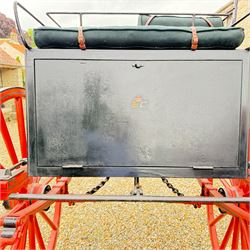 Holland & Holland Tandem Cart - Althorp Spencer Family Estate

A two wheeled tandem cart or cocking cart by Holland & Holland Coach Builders, London, with black painted bodywork, red painted shafts and running gear, red wooden spoked wheels with rubber tyres, green upholstered seating and a rear perforated metal footboard. The cart is fitted with carriage lamp brackets (lamps next lot), green buttoned cushions with leather retaining straps, side louvered body panels, footrests, leaf spring suspension and shafts for horse use. The carriage incorporates an adjustable body position, operated by a lever, allowing the body to be moved forwards or backwards to alter the weight distribution. Formerly owned by the family of Lady Diana Spencer,
Sympathetically conserved by Woods of Fairbourne Carriages Ltd, Kent.

Features:
• Brass maker’s plaque for Holland & Holland Coach Builders, London
• Two wheeled tandem cart
• Black painted body with red painted shafts and running gear
• Red wooden spoked wheels with rubber tyres
• Green upholstered cushions with leather retaining straps
• Adjustable carriage body for weight distribution
• Lever operated adjustment mechanism
• Perforated rear footboard
• Side footrests
• Louvered side panels
• Leaf spring suspension
• Rear opening storage compartment
• Decorative painted armorial motif to rear panel
• Fitted carriage lamps shown, not included in the lot (available as next lot)
• Conserved by Fairbourne Carriages Ltd
• Provenance: The Althorp Attic Sale including The Spencer Carriages, lot 195, 7 July 2010

Dimensions:
Overall length 396 / 198cm
Width 155cm
Height 190cm

Wheel Diameters:
Wheels: 148cm

Seating:
Driving seats: 2
Passenger seats: 2