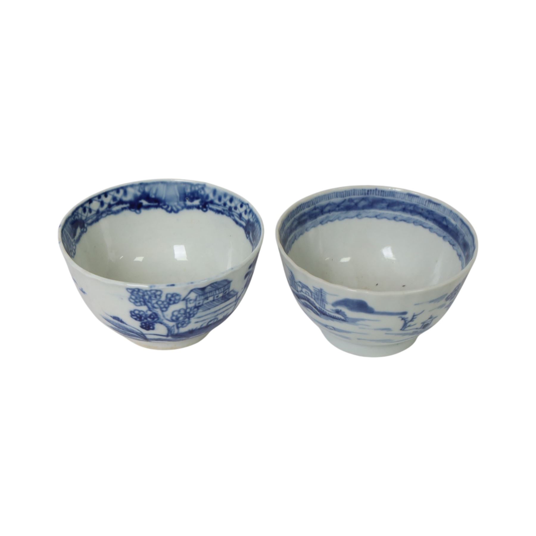 Two 19th century Chinese blue and white tea bowls, each decorated with traditional landscapes, together with two similar saucers, tea bowl H5cm, D9cm  
