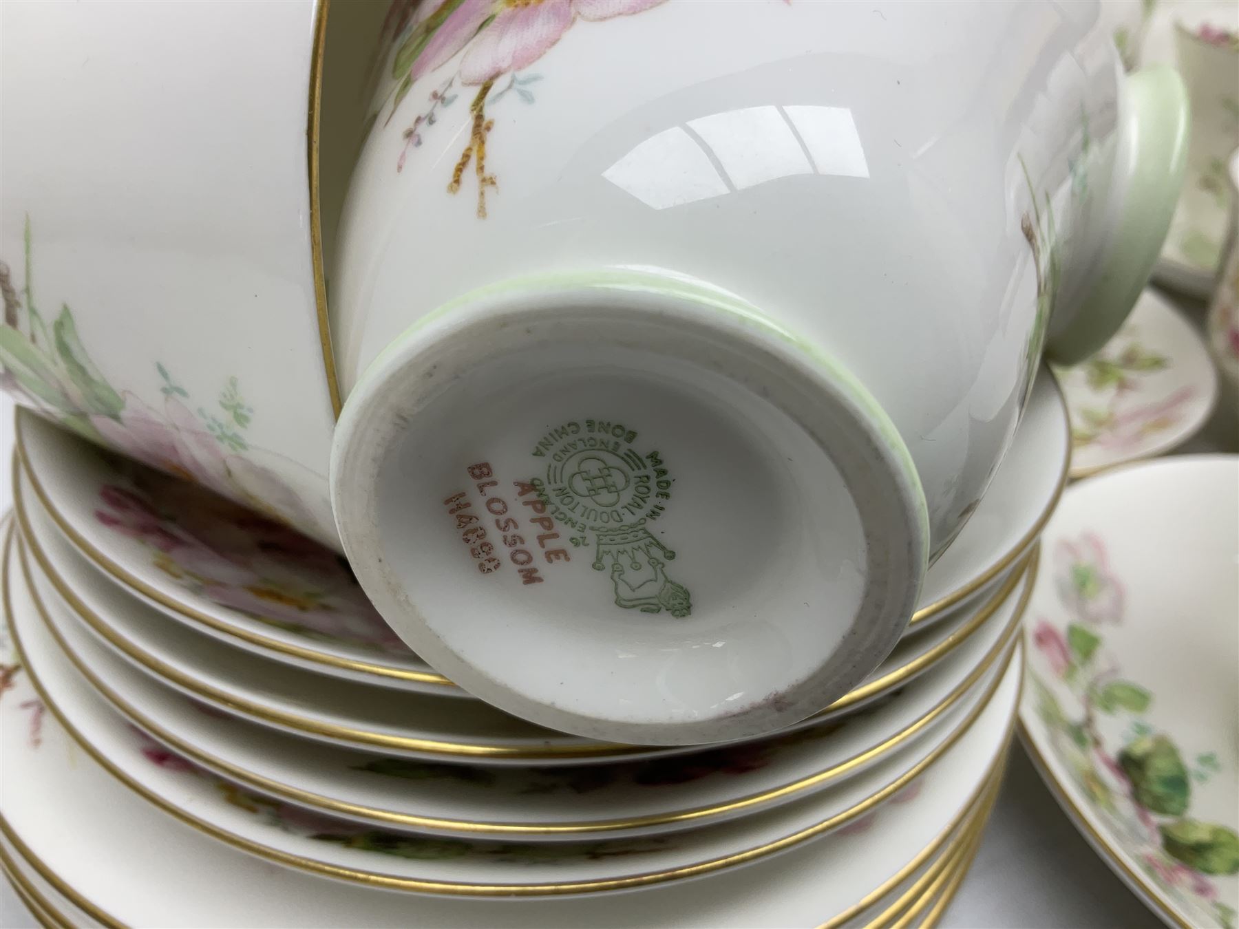 Royal Doulton Apple Blossom pattern tea service for twelve, comprising twelve saucers, twelve tea plates, twelve teacups, milk jug, sucrier and two cake plates