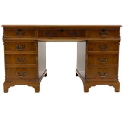 Yew wood twin pedestal desk, fitted with nine drawers, inset green leather writing surface
