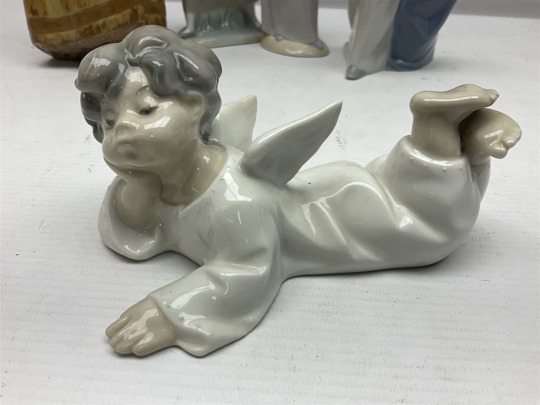 Four Lladro figures, including Girl With Cockerel no 4591, Gres Lonely no 2076 etc together with Nao figure 