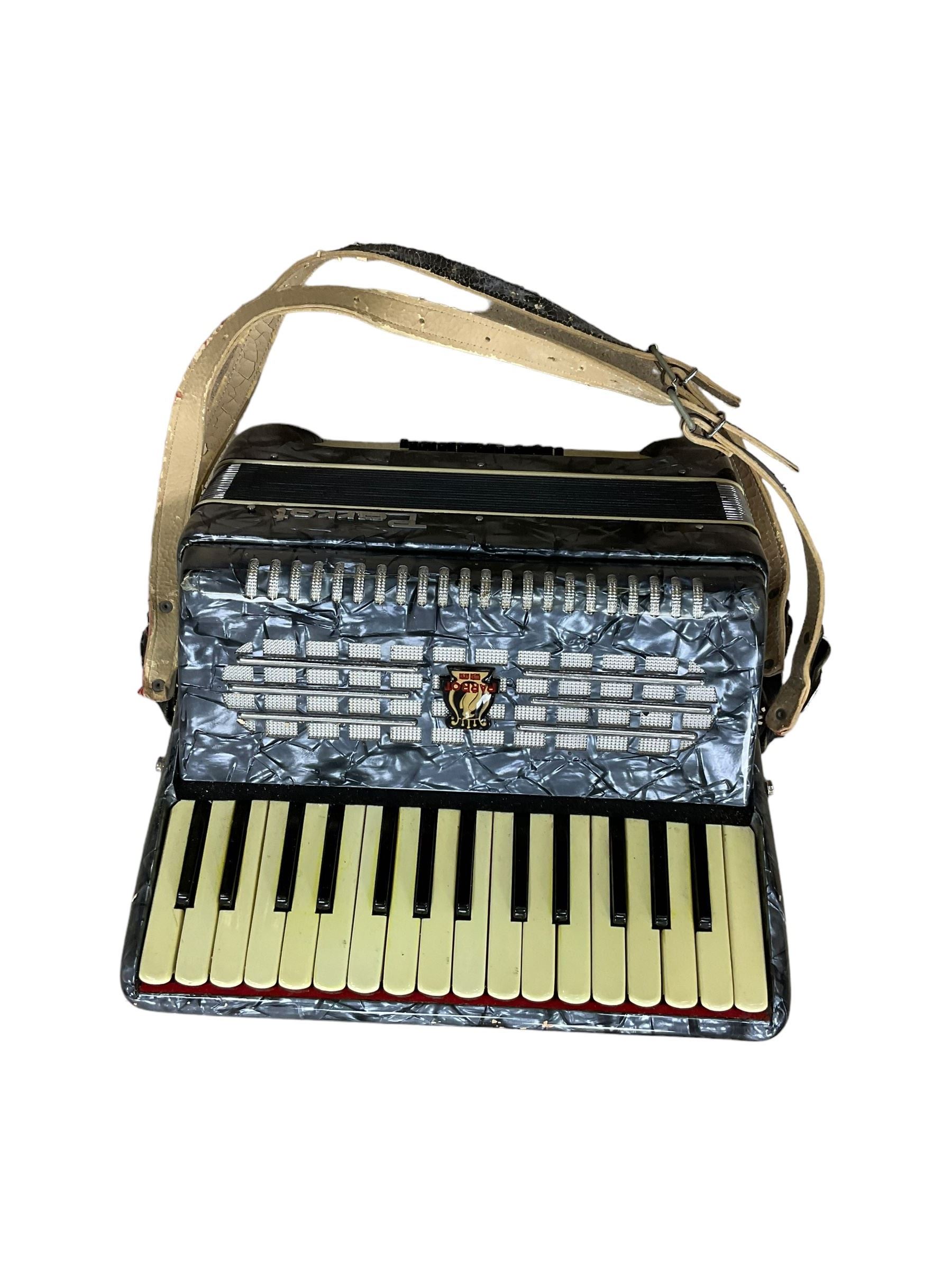 Parrot- Chinese accordion, with 30 treble keys and 24 bass buttons, 14 fold bellows. In a velvet lined hard case.