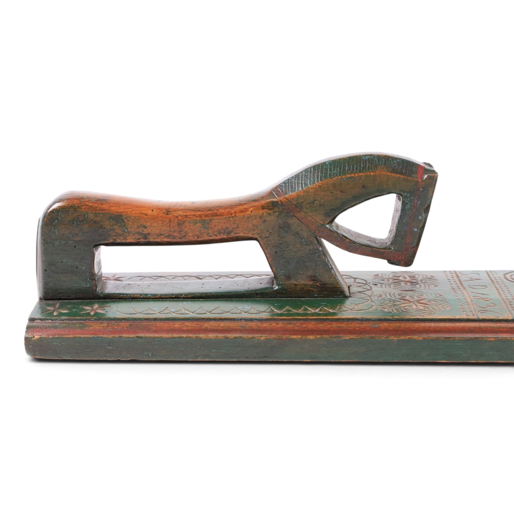 Mid 19th century Norwegian carved mangle board, dated 1836, of rectangular form with carved dala horse handle, with geometic red floral carvings upon a green ground, L63cm