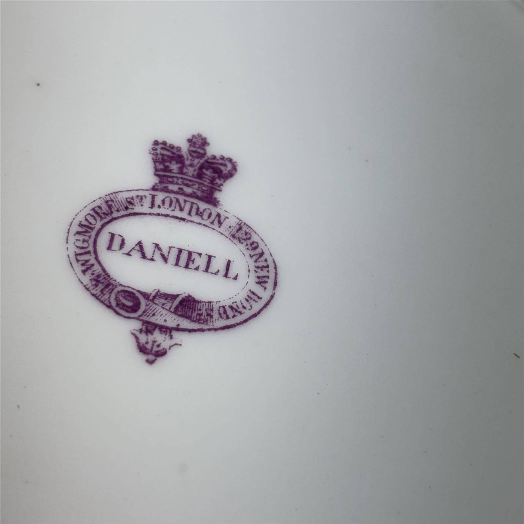 Pair of 19th century H&R Daniel porcelain armorial plates, each decorated with a central painted lion crest and banner inscribed with the Lloyd family motto in Welsh, 'Heb dduw heb ddym, Dhuw a digon' (Without God without anything, God is enough), within a gilt detailed and turquoise jewelled rim, each with puce printed mark verso, D26cm
