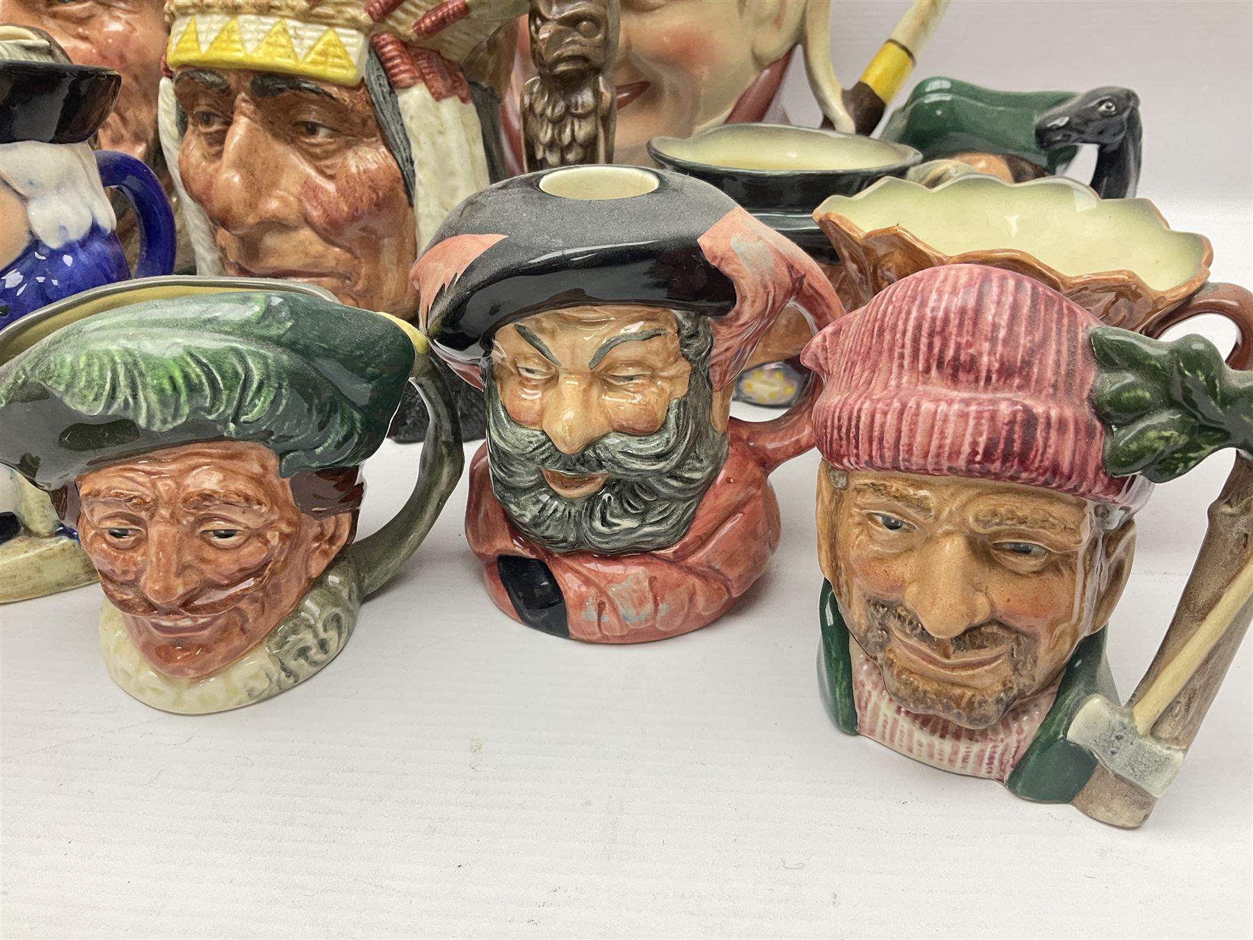 Collection of Royal Doulton and Beswick character jugs of various sizes, including North American Indian D6611, The Falconer D6533,  Tony Weller 281, Sairey Gamp 371 etc