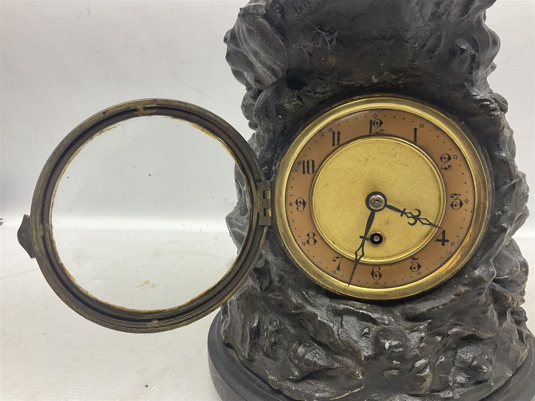 Early 20th century spelter effect figure of a sailor standing in the bow of a boat scanning the horizon, on a simulated rock base with a plaque entitled 'Rescue', base fitted with a timepiece clock movement and two-part dial, with pierced hands, gilt dial centre and ivorene chapter ring written in Arabic numerals, German HAC spring driven going barrel movement wound from the front; with pendulum H65.5cm
