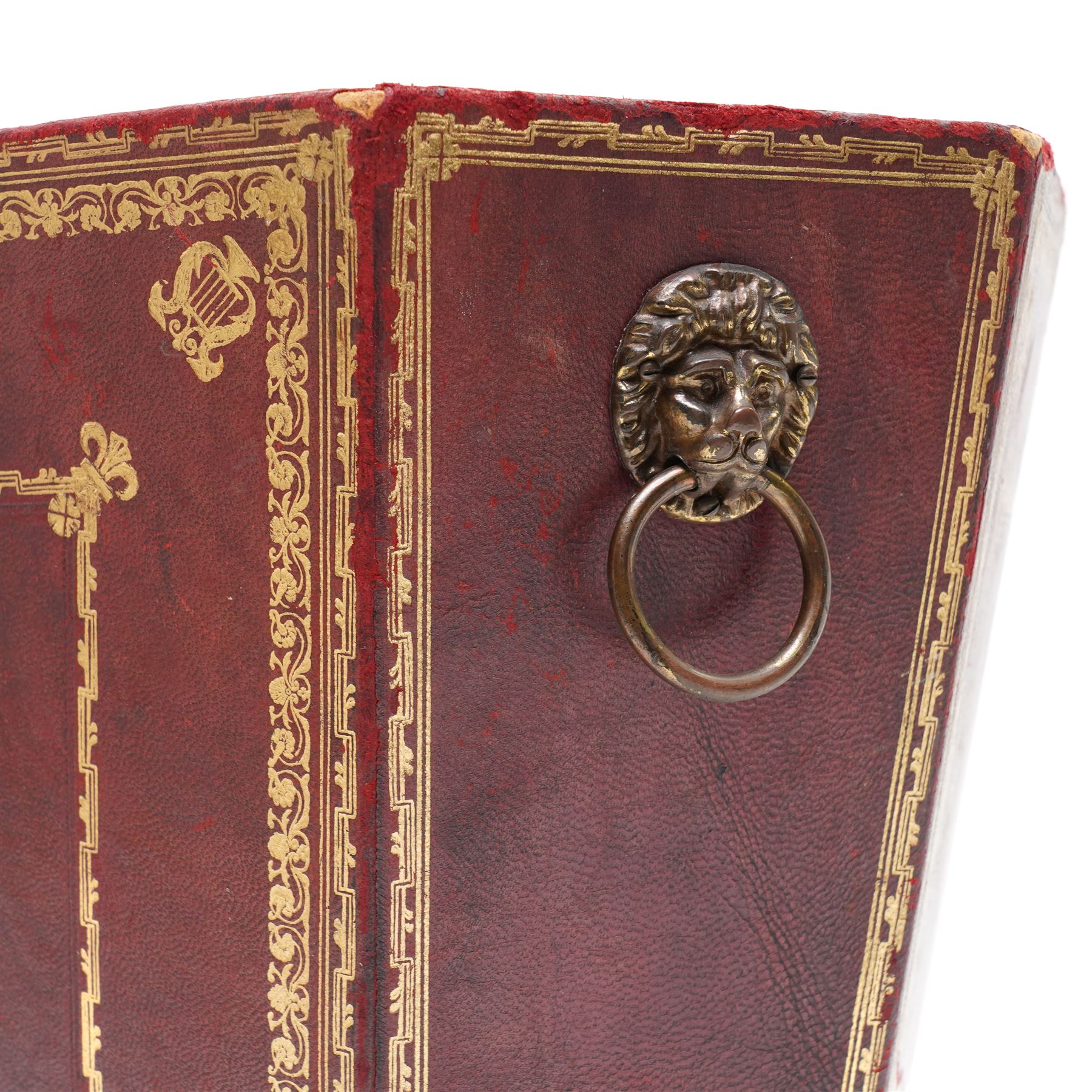 Regency style burgundy leather waste paper bucket of tapering octagonal form with gilt-tooled borders, sides fitted with lion mask ring handles, interior lined with marbled paper, circa 1900