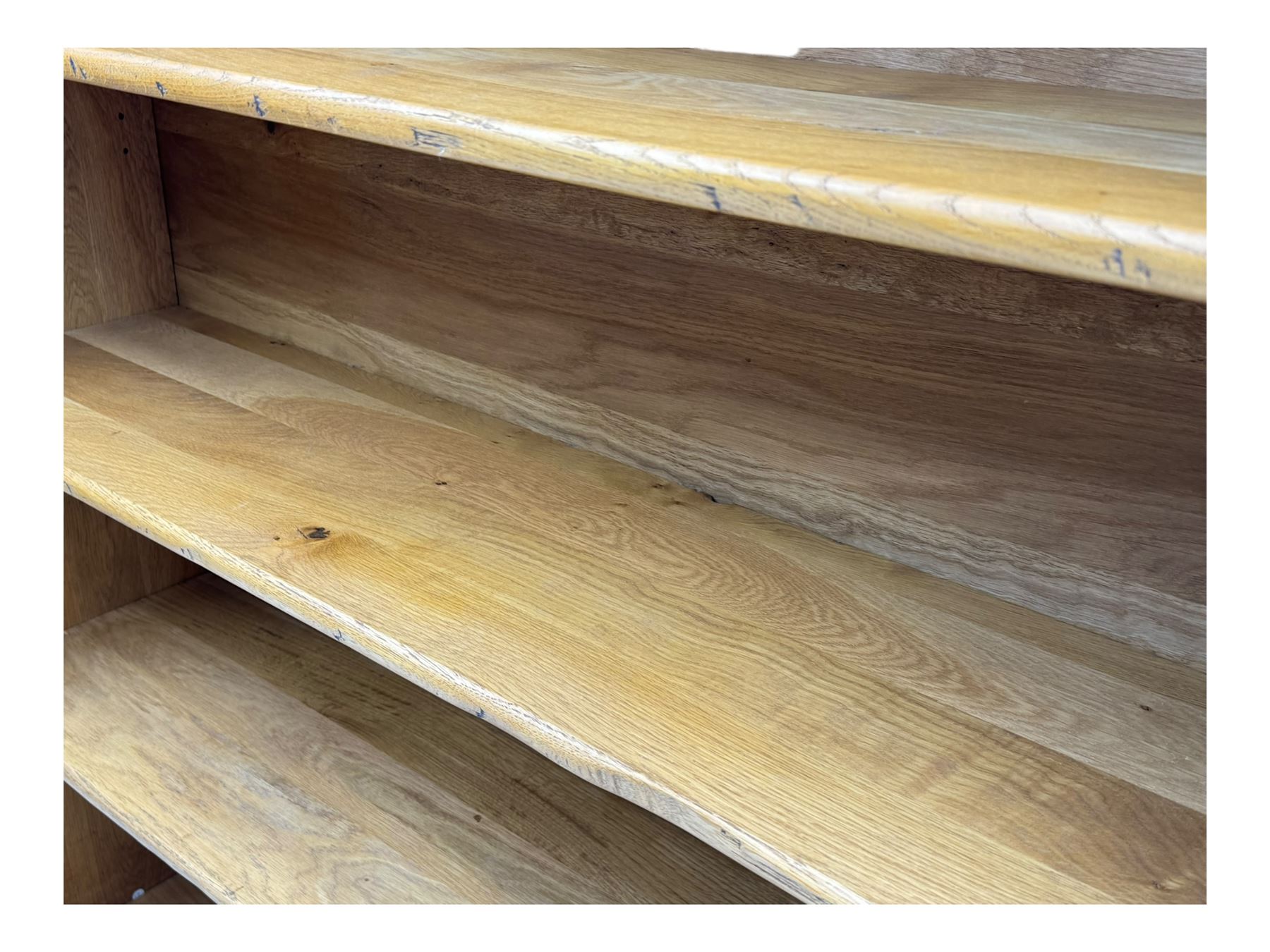 Contemporary French provincial design oak open bookcase, with projecting moulded cornice above a boarded back, fitted with four adjustable shelves, on bracketed plinth base