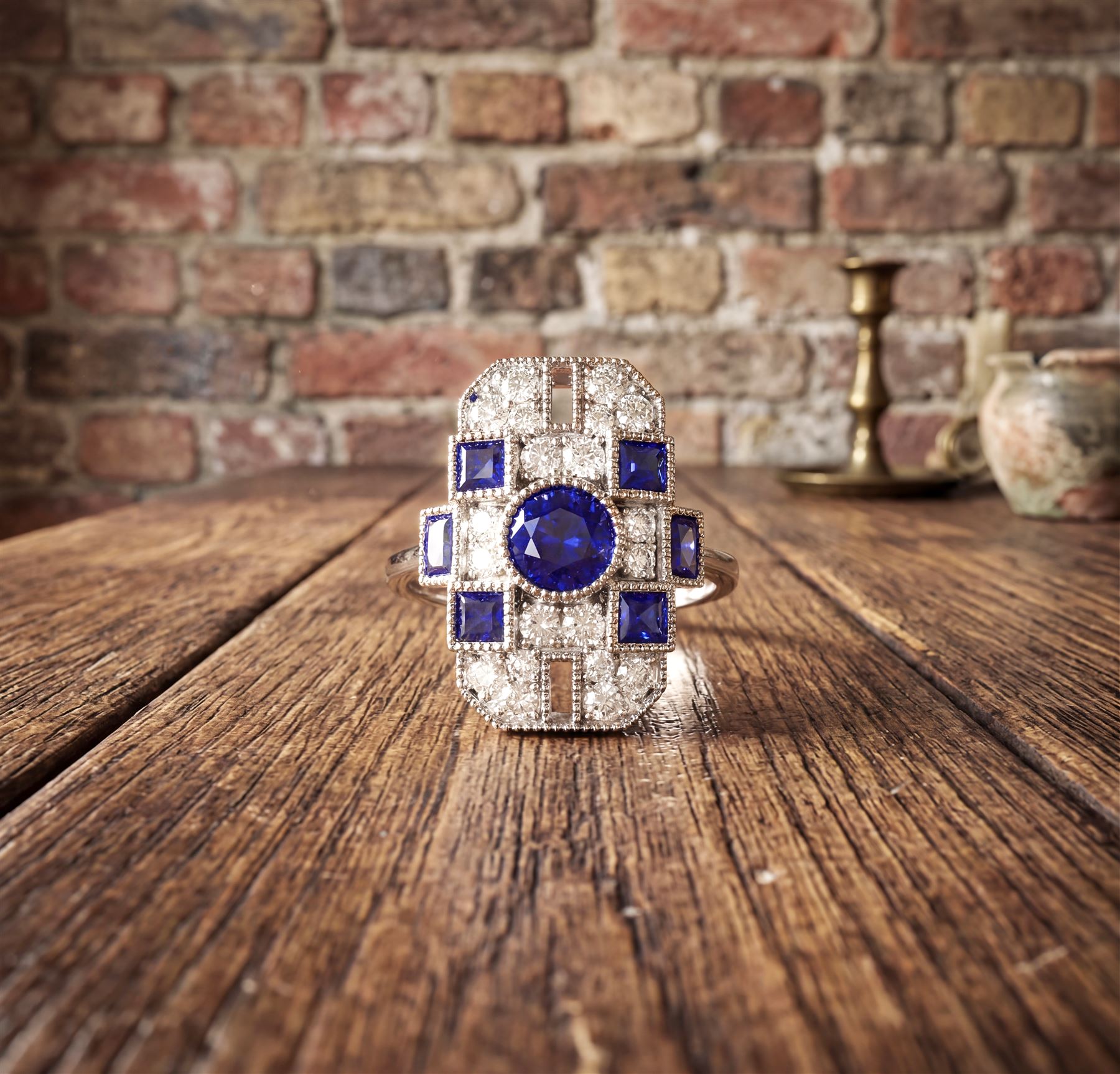 Platinum sapphire and diamond panel ring, milgrain set with round and calibre cut sapphires and round cut diamonds, stamped Pt 950, total sapphire weight 0.87 carat, total diamond weight 0.46 carat