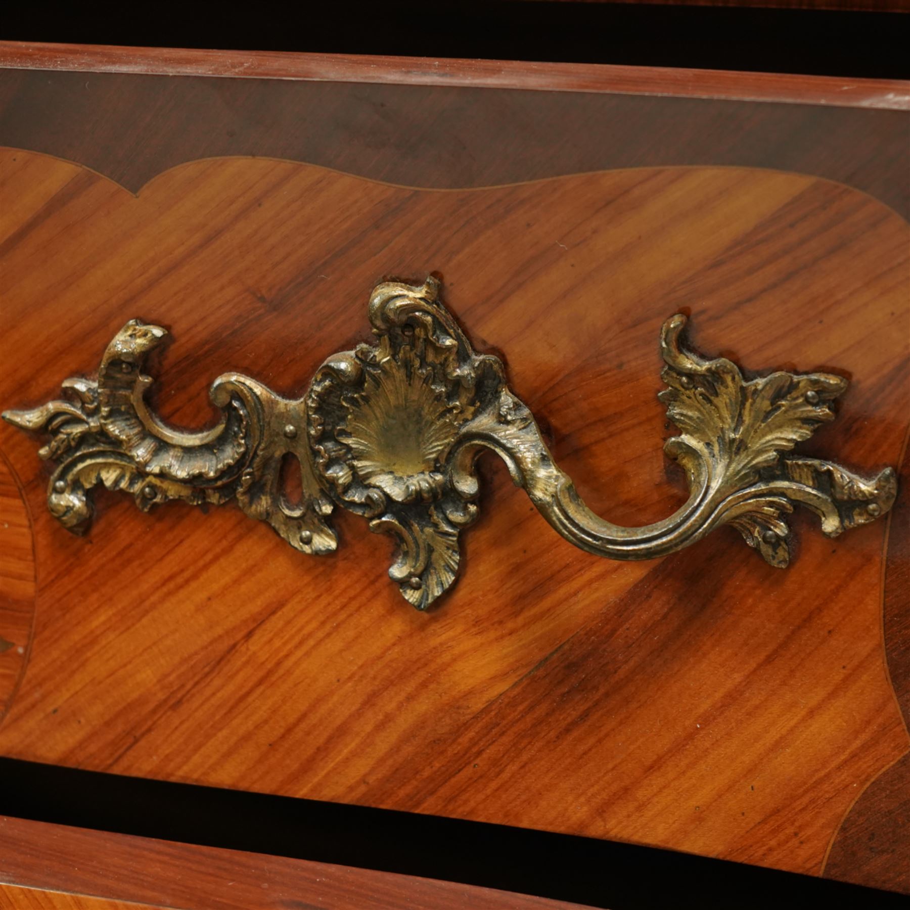 French Louis XV revival bombe commode, early 20th century, with variegated marble top above two drawers inlaid with floral marquetry, gilt metal rococo handles and mounts, kingwood and tulipwood veneers laid in chevron and quartered patterns, on cabriole supports with gilt sabots