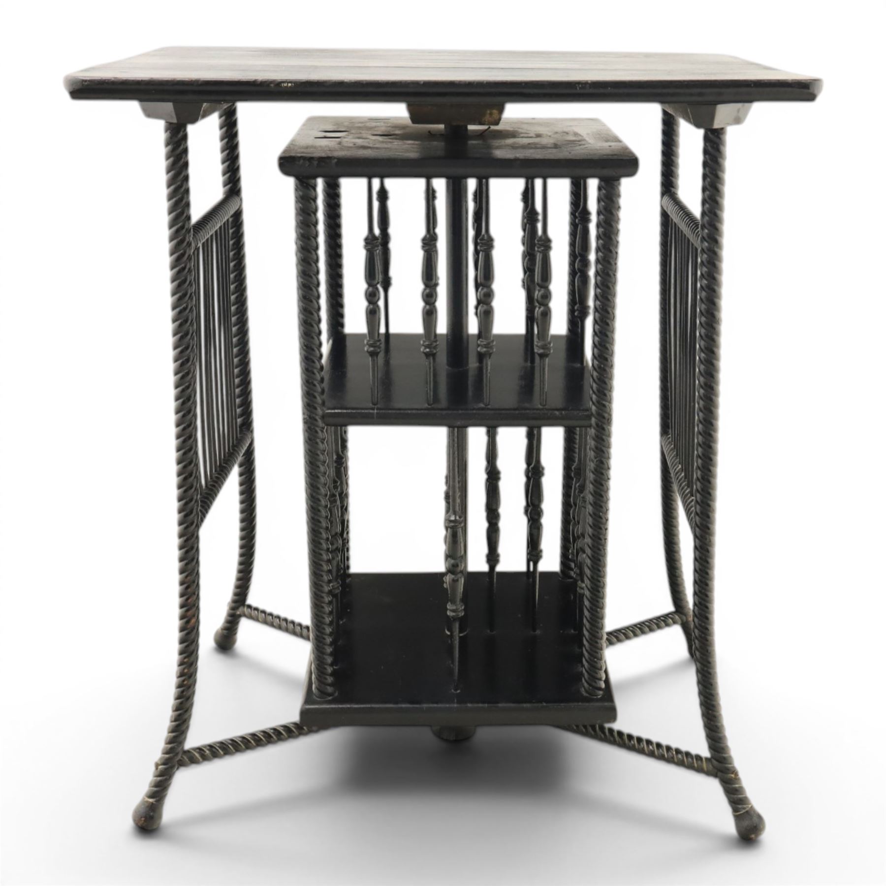 Edwardian black painted side table with incorporated revolving bookcase, supported on barley twist legs