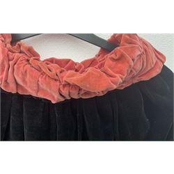 Full length 1930's childs black velvet cape, with ruched collar and red velvet lining, with a single button neck fastening 