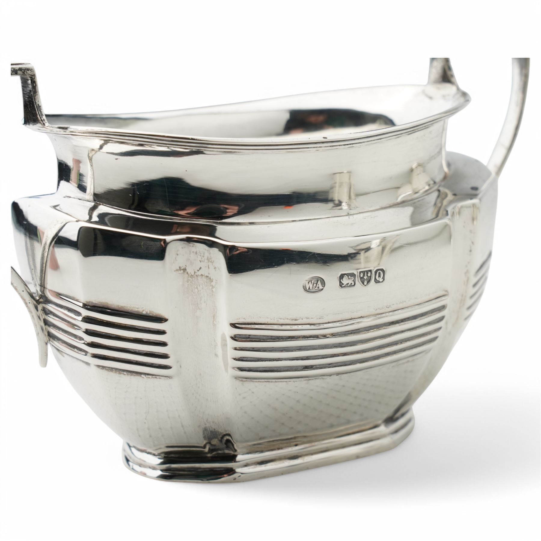 Late Victorian silver three piece tea set of panel sided oval design, the teapot with ebonised handle and lift, Chester 1898/99 Maker Florence Warden and William Aitken