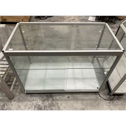 Aluminium and glass two tier display cabinet on castors and inside lights - THIS LOT IS TO BE COLLECTED BY APPOINTMENT FROM DUGGLEBY STORAGE, GREAT HILL, EASTFIELD, SCARBOROUGH, YO11 3TX