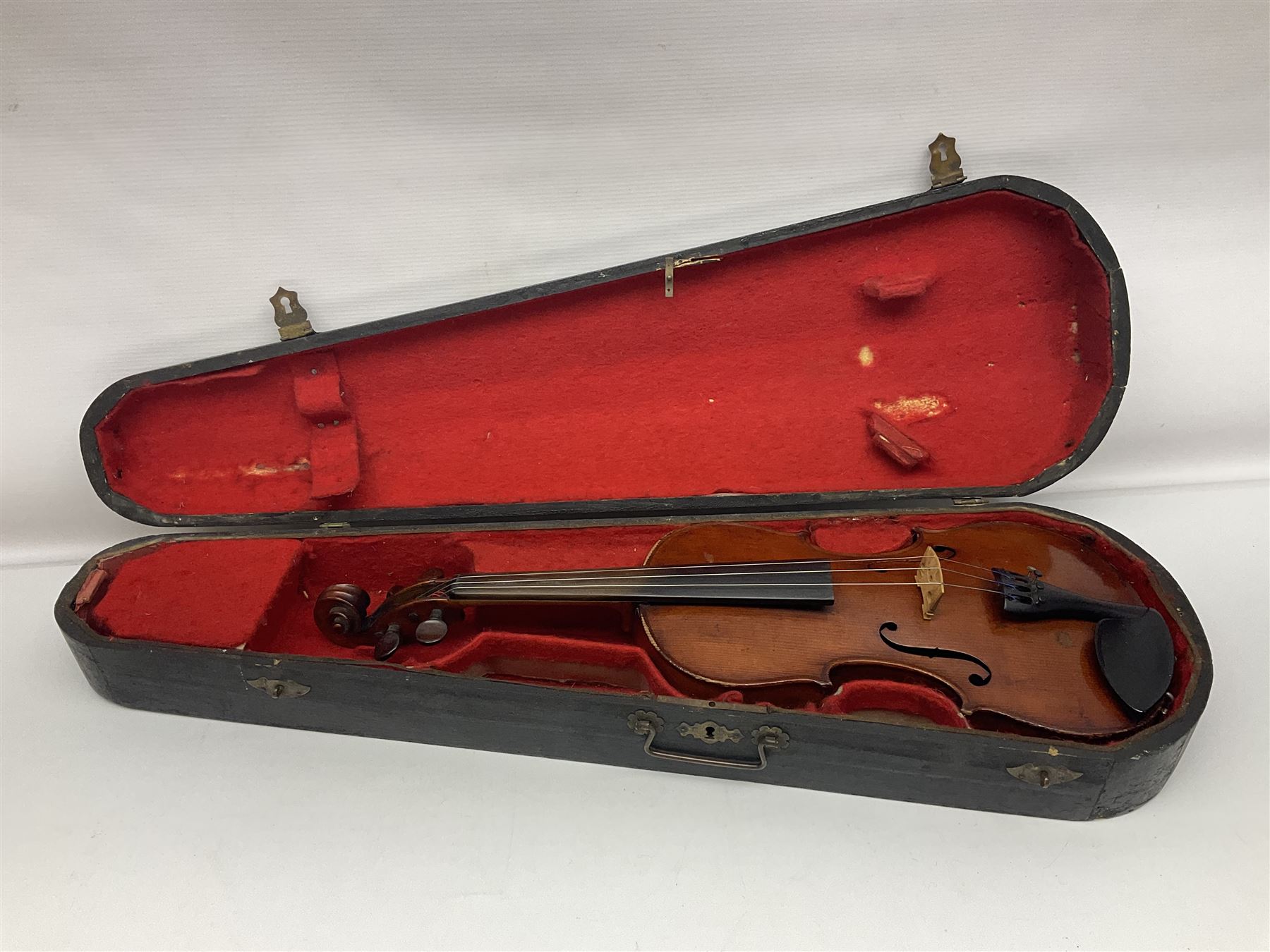 German violin c1890 with 36cm two-piece maple back and ribs and spruce top; bears label 'Antonius Stradivarius Cremona Faciebat Anno 1729' L59.5cm overall; in ebonised wooden 'coffin' case; and two German violins c1890 for completion - one bearing a Stradivarius label, the other a Ruggeri label; both in carrying cases (3)