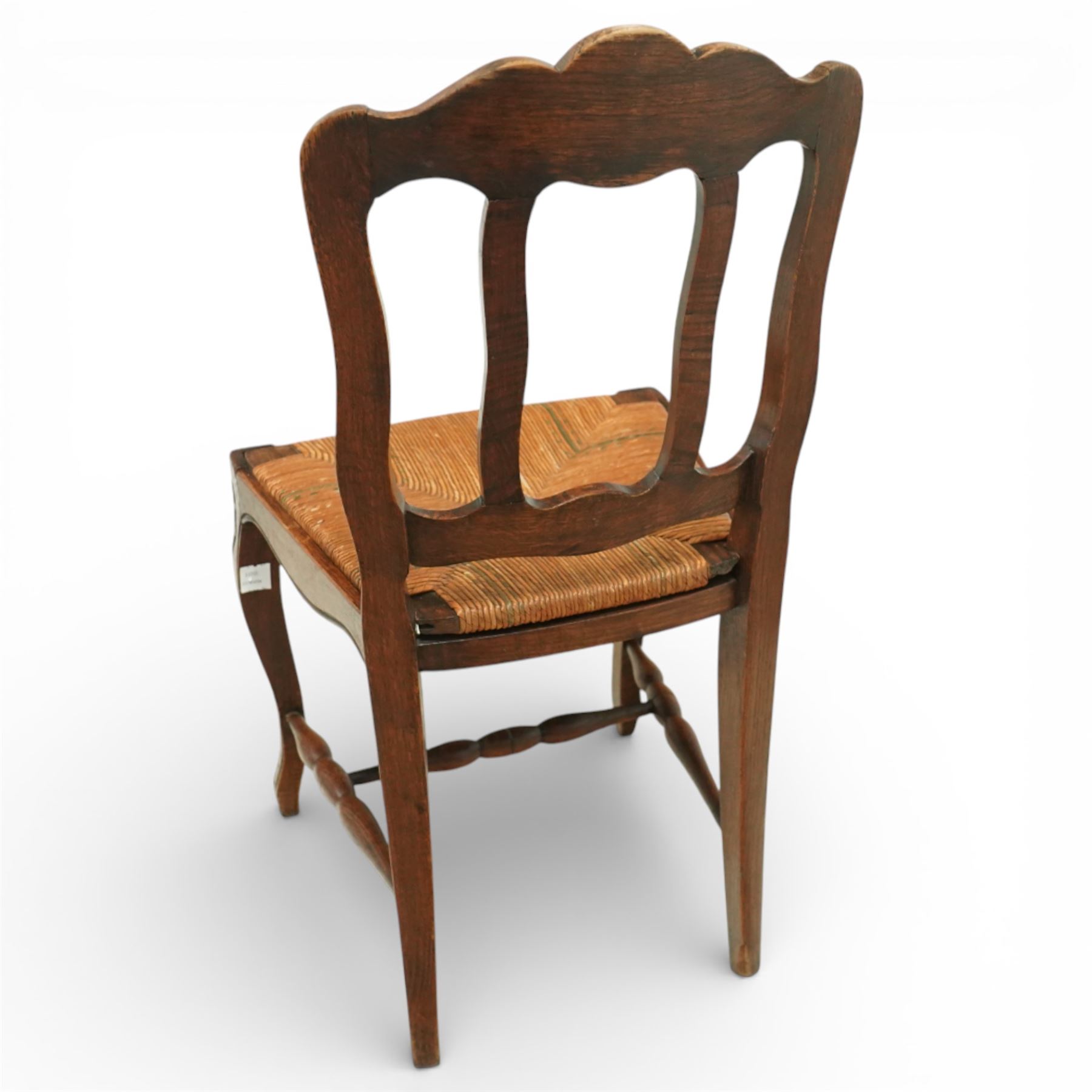 20th century French oak drawer-leaf extending dining table and six chairs, the rectangular parquetry top with moulded edge and rounded corners, pull-out draw leaves extending the table to 240cm, carved frieze with foliate detail, raised on cabriole supports with scroll terminals, the six matching chairs with shaped backs carved with floral motifs, paper cord seats woven with a green pattern, cabriole front supports and turned stretchers