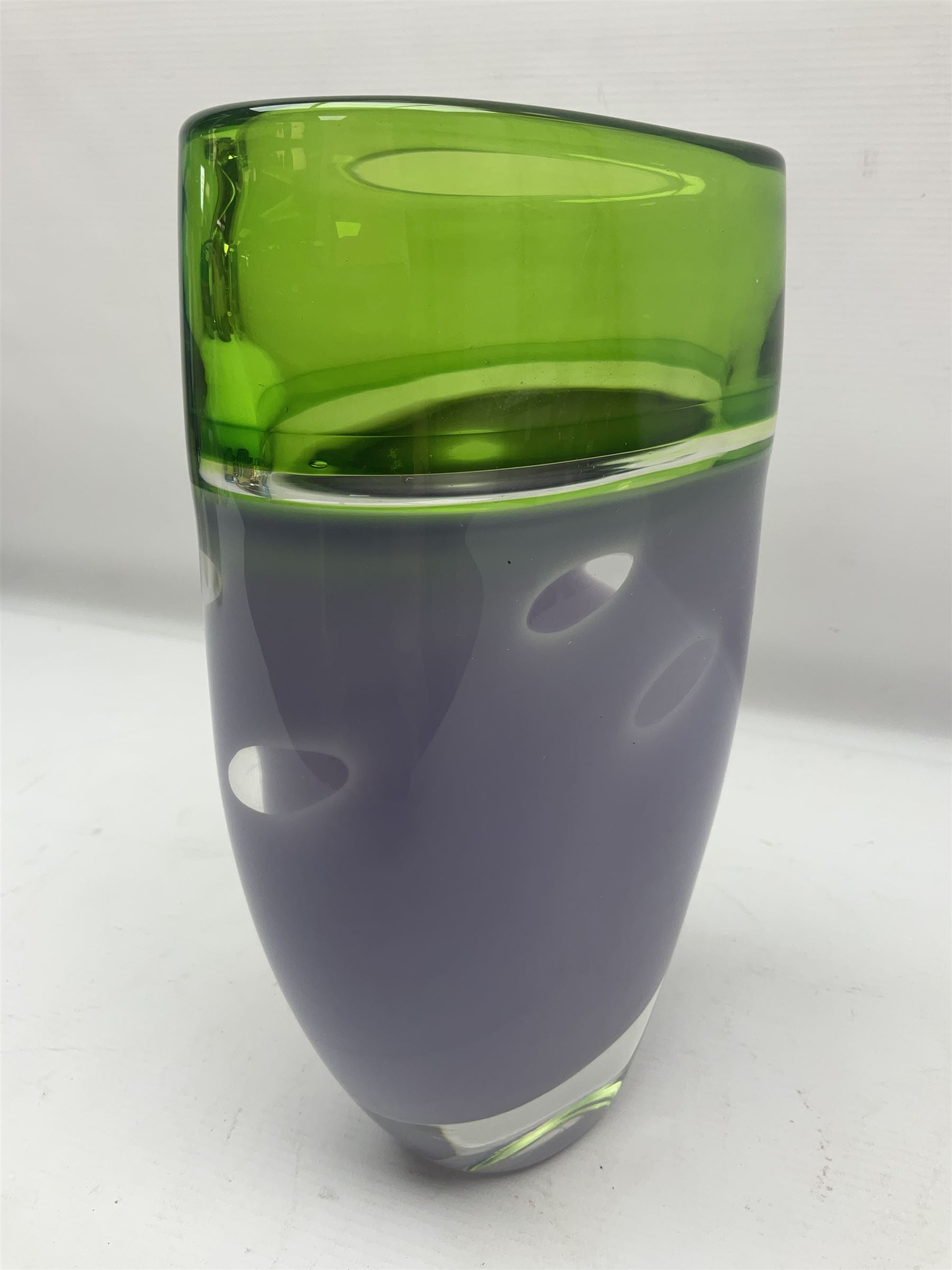Stuart Akroyd glass vase, green banded top and opaque purple lower section with bubble inclusions, with sticker and engraved signature beneath, H25cm