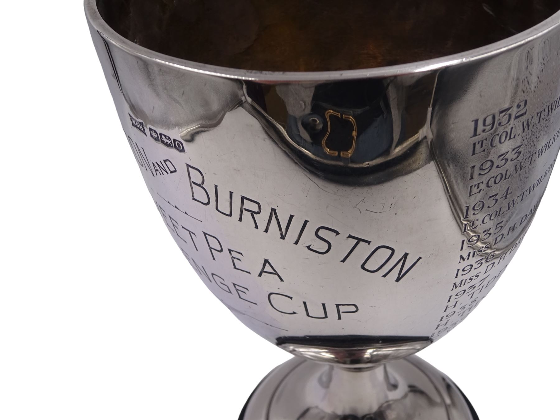 1930s silver trophy cup, of plain form, upon knopped stem and circular stepped foot, body with presentation engraving 'Cloughton and Burniston Sweet Pea Challenge Cup' with winners engraved verso, hallmarked Walker & Hall, Sheffield 1931, upon ebonised base, including base H28.7cm