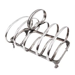 Edwardian silver toast rack, with five kidney shaped bars and loop handle, upon rectangular base and four claw feet, hallmarked Joseph Rodgers & Sons, Sheffield 1908, H9cm