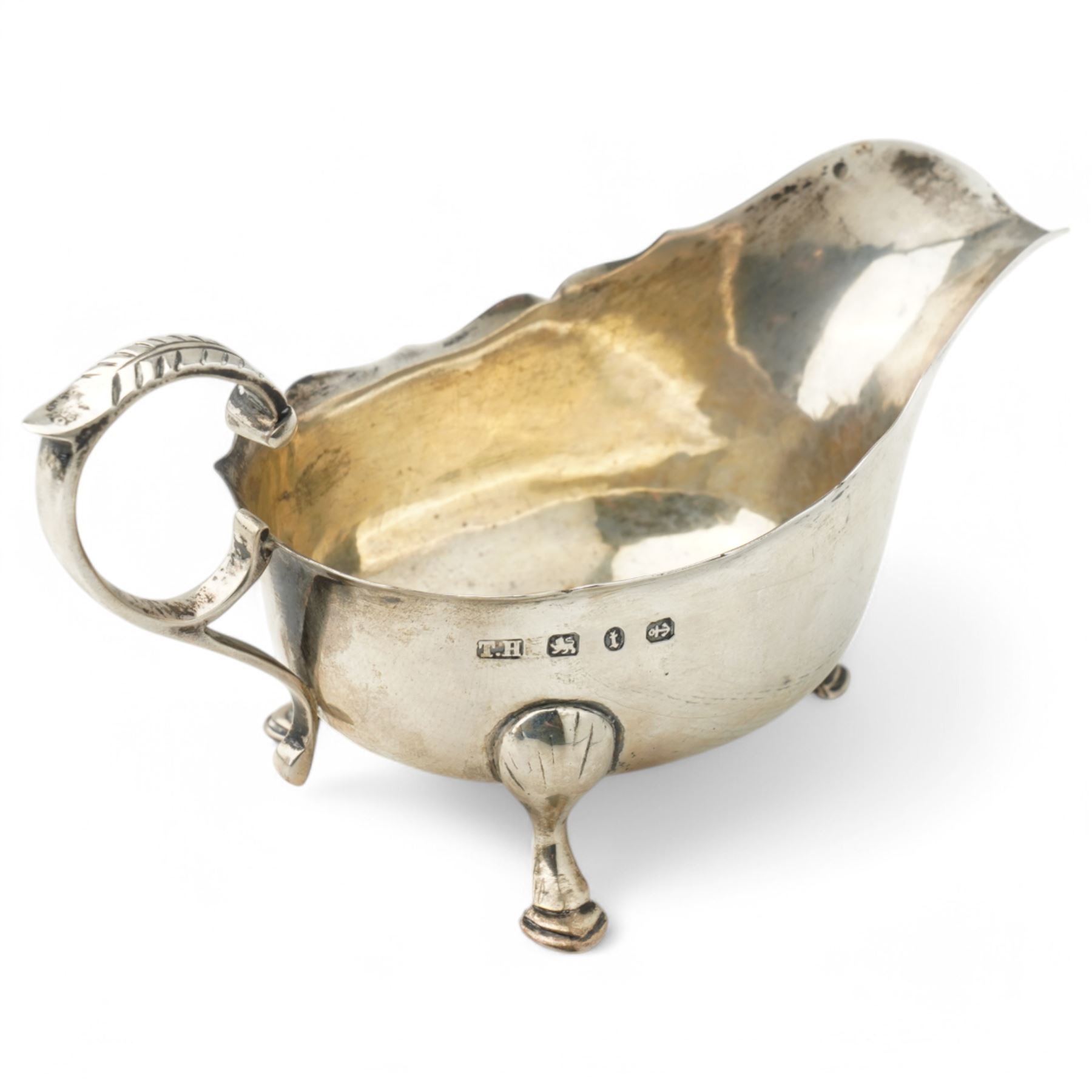 George III silver cream jug with gadrooned edge and leaf capped handle on shaped supports London 1817 Maker Robert Peppin and a small Victorian silver sauce boat with crimped rim Birmingham 1893 Maker Thomas Hayes (2)