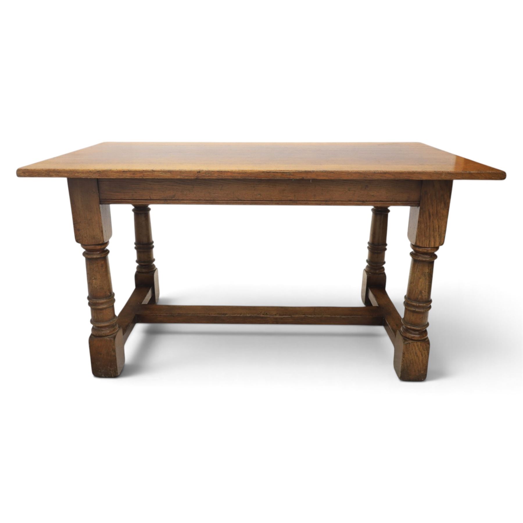 Titchmarsh & Goodwin style solid oak refectory table, rectangular top raised on block and turned supports united by a full length undertier