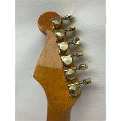 Copy of a Fender Stratocaster electric guitar in black with Wilkinson bridge, lock-in tuners, synchronised tremolo and various patent numbers; L99cm; in hard carrying case with strap and digital tuner
