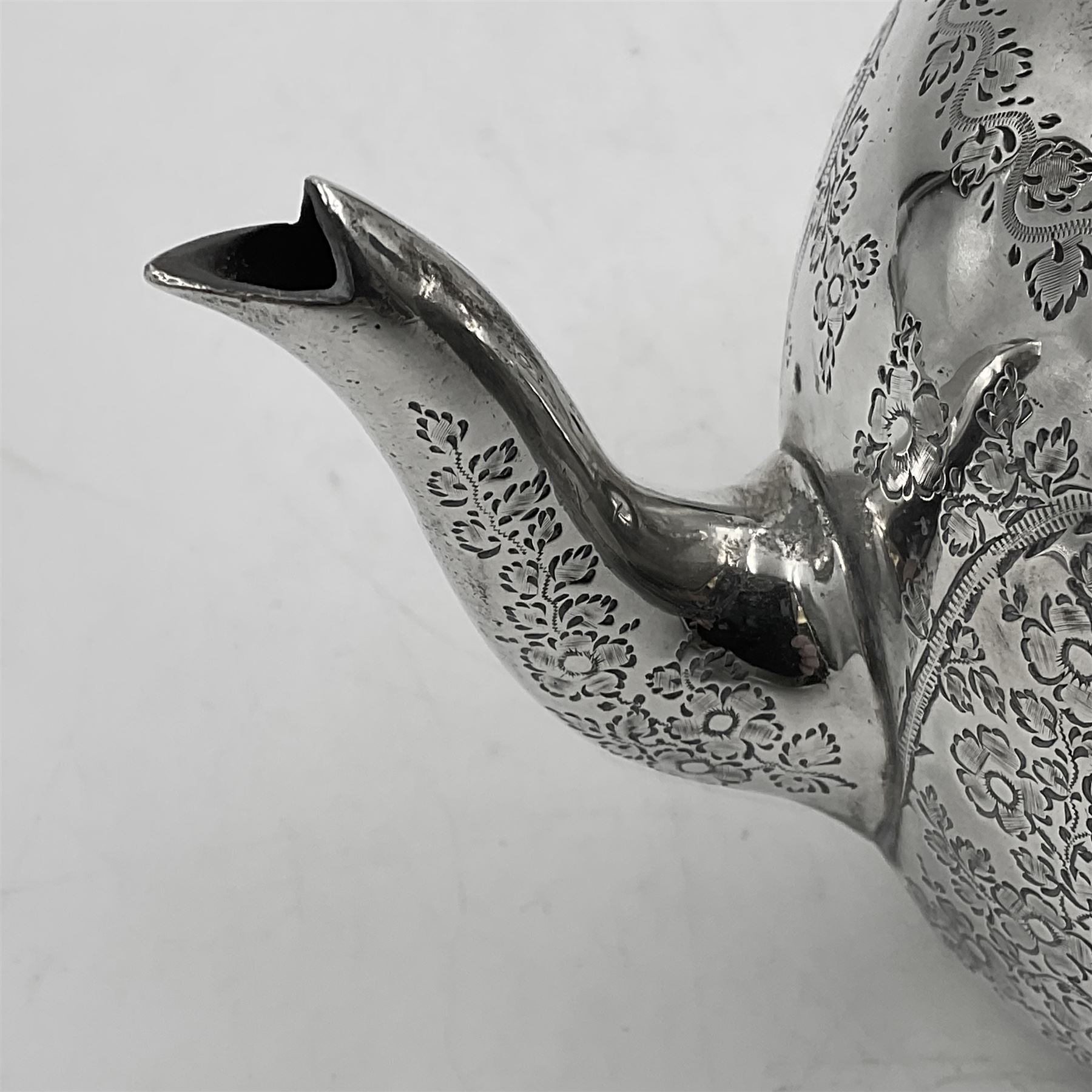 Late Victorian silver bachelors three piece tea service, comprising bullet shaped teapot, open sucrier and milk jug, each engraved with monogram surrounded by birds upon and amidst a blossoming vine, the teapot with scroll capped curved wooden handle and wooden finial to cover, hallmarked Wakely & Wheeler, London 1890, teapot including handle H12cm, sucrier H5.5cm 