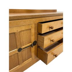 Mouseman - oak dresser, rectangular adzed top with raised back over three central drawers and two flanking cupboards, enclosed by panelled doors with wrought metal fixtures, the canted upright carved with mouse signature, on octagonal feet, by the workshop of Robert Thompson, Kilburn