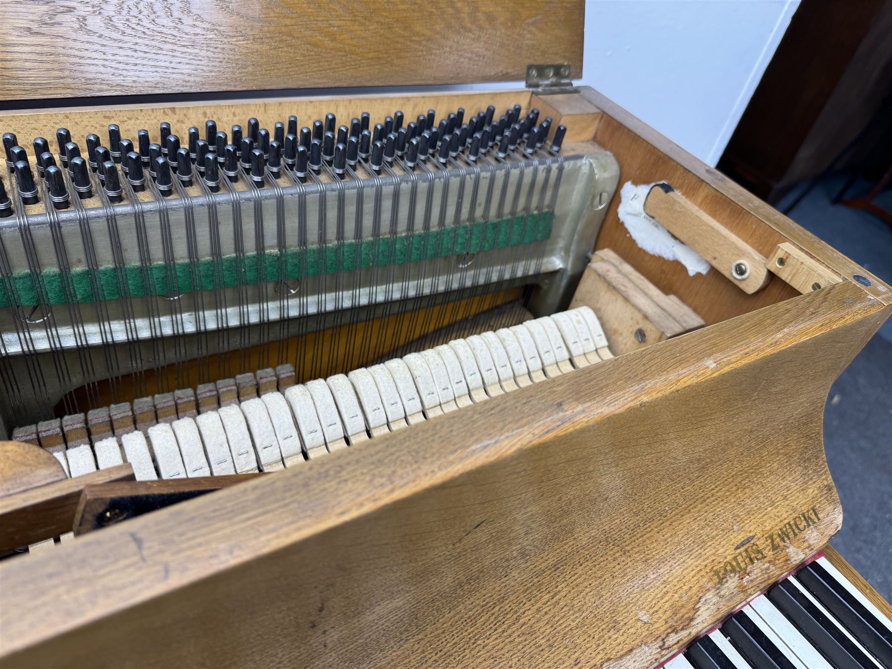 Louis Zwicki - mid-20th century oak cased compact piano, fitted with a folding music rest and full keyboard, dual brass pedals