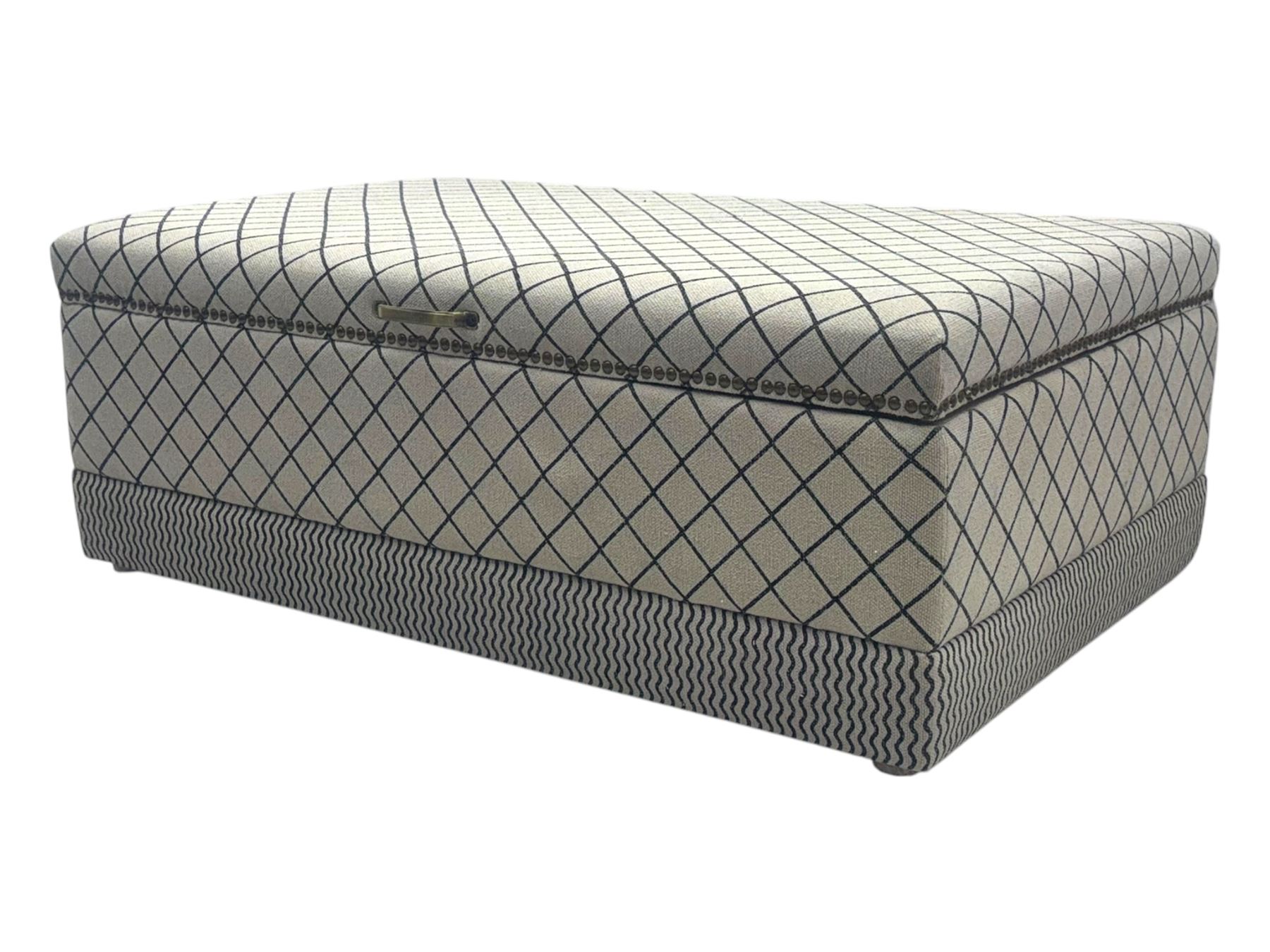 Oka - contemporary mango wood upholstered ottoman, rectangular frame with a printed cotton dhurrie featuring a diamond pattern and wavy stripe border, fitted with brass hinges, decorative studs, and handle
