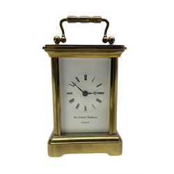 Matthew Norman - miniature 20th century brass carriage clock, 8-day timepiece movement in a corniche case with an enamel dial, Roman numerals and moon steel hands, with a jewelled lever platform escapement. With key.