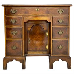 Georgian design figured walnut knee-hole desk, the rectangular moulded top with crossband, fitted with frieze drawer over six smaller drawers with oak linings, recessed cupboard enclosed by stepped arch mould door, on bracket feet