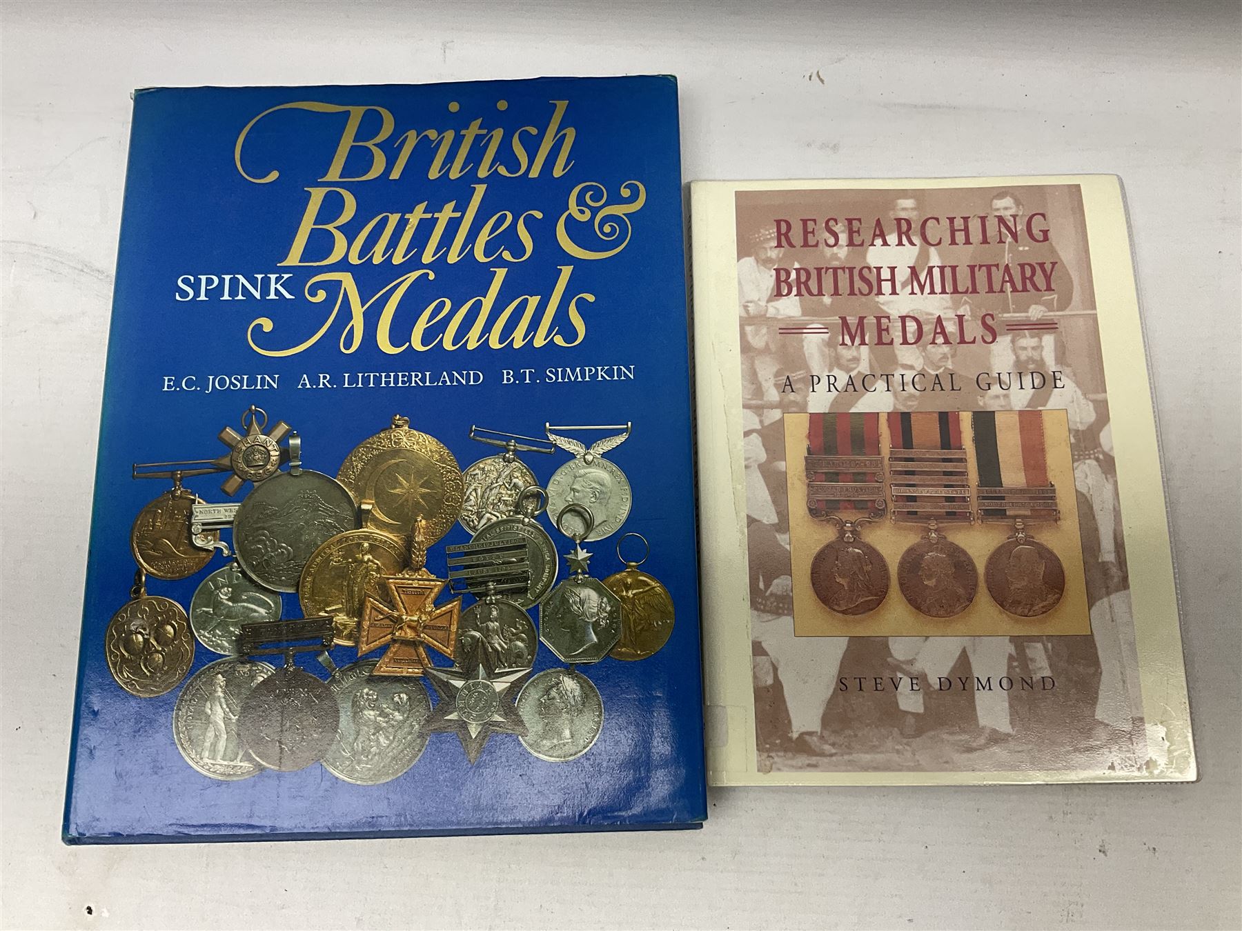 Eleven medal reference books including Ian Bisset: The George Cross; Spinks British Battles & Medals; William Spencer: Medals - The Researchers Guide; John D. Clarke: Gallantry Medals & Decorations of the World; Officers of The Green Howards 1931-1972; and six others (11)