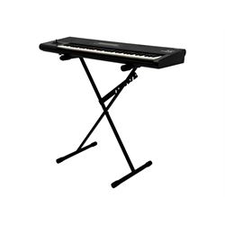 Korg M1 keyboard synthesiser, 61 velocity-sensitive keys with integrated multi-effects and eight-track sequencer, mounted on an adjustable black tubular X-frame stand with rubber end caps