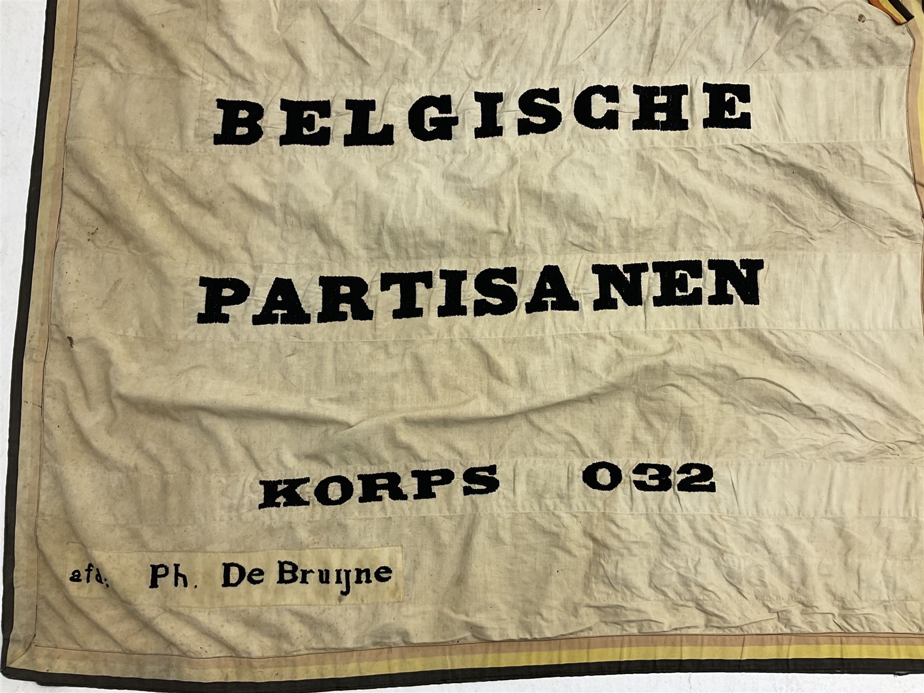 WW2 Belgian Partisan/Resistance two-sided banner embroidered in black on a cream ground 'Belgische Partisanen Korps 032 afd: Ph: De Bruyne' within a Belgian flag border; on wooden pole with gilded metal lion and laurel wreath finial