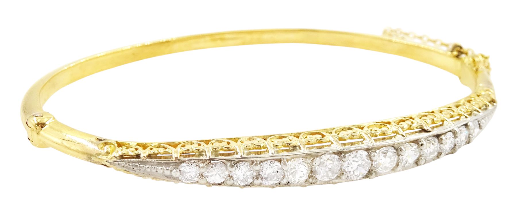 Early 20th century gold and silver diamond hinged bangle, thirteen graduating old cut diamonds, within a fancy scroll design gallery, total diamond weight approx 2.10 carat